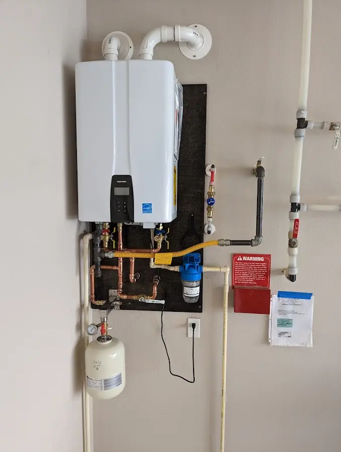 Professional plumber installing copper piping in a Boulder home